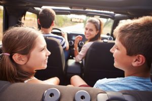 Parents Taking Children On Trip In Open Top Car